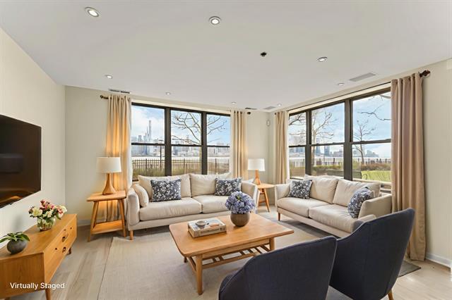 Virtually staged living room with Manhattan skyline views at Residence B03, 24 Avenue at Port Imperial
